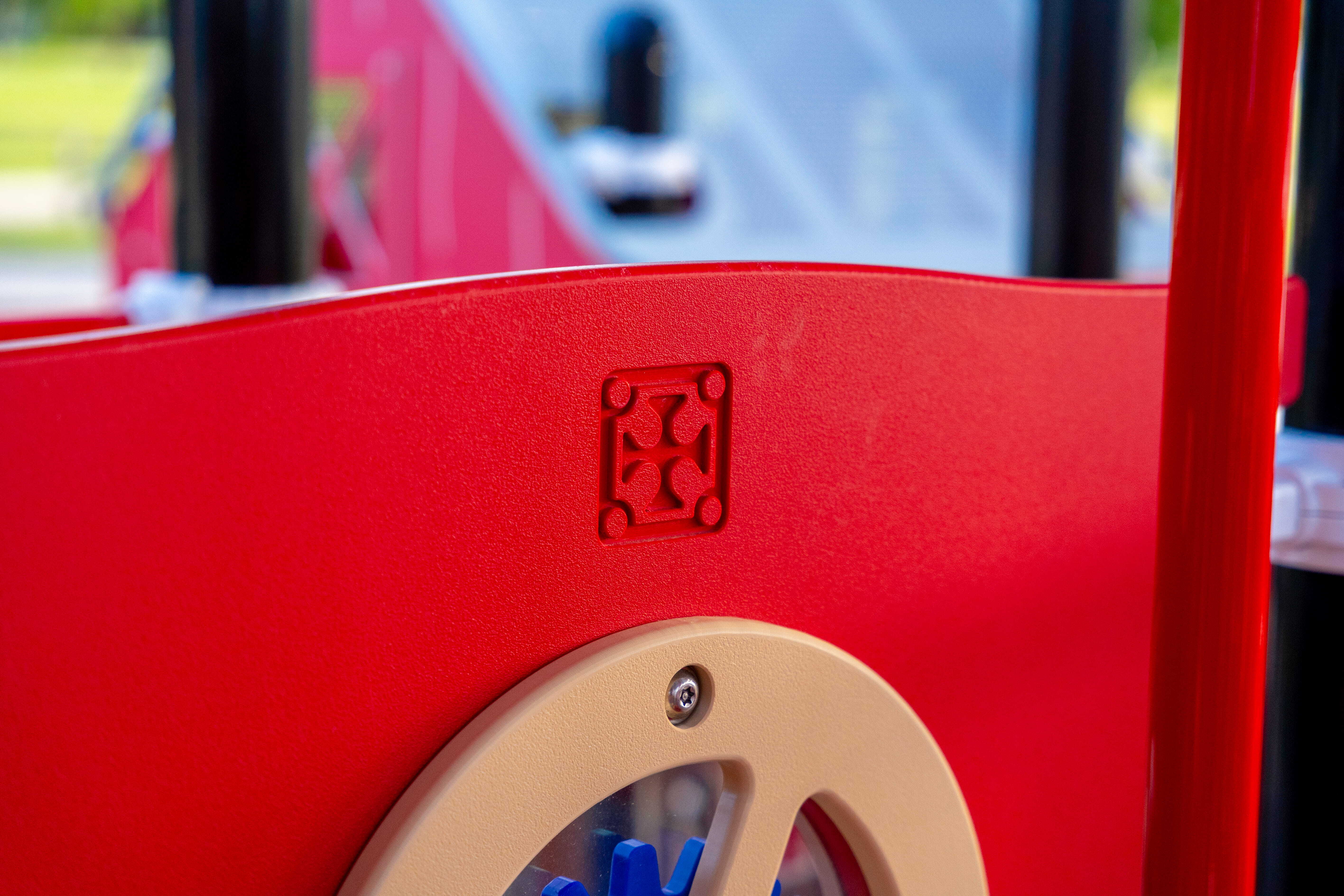 Playcraft emblem on a red activity panel with a circular play feature at Heritage Park.
